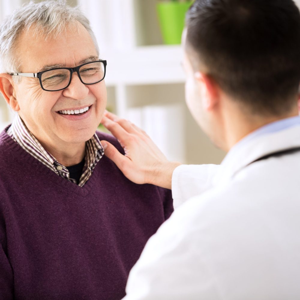 Smiling happy old patient visit doctor